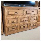 Three section entertainment center, comprising a middle chest of 8 drawers flanked by two shelf towe
