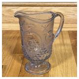 SS OLYMPIA GLASS PITCHER | Pressed glass depicting cannons, ships and naval motifs; h. 9 in.