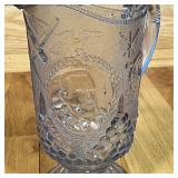 SS OLYMPIA GLASS PITCHER | Pressed glass depicting cannons, ships and naval motifs; h. 9 in.