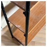 Simple five tier shelf / bookcase, with wood slabs between two black tube frames; 69 x 29 x 11 in.