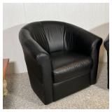 Black leather armchairs, barrel back, swiveling, in overall very good condition; h. 31-1/2 x w. 34 x