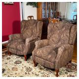 PAIR RECLINING ARMCHAIRS | Wingback reclining armchairs having textured paisley upholstery, fronted 
