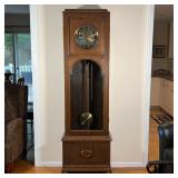 GERMAN TALL CASE CLOCK | Wood case with a beveled glass door, 8 rod chimes, brass pendulum, the face
