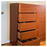 Danish modern wood cabinet having a wardrobe door with shelves on the right, and five drawers on the
