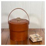 LEATHER WRAPPED ICE BUCKET | Wrapped in brown leather; h. 12-1/2 in. (over handle); plus a set of li