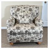  floral fabric upholstery and a matching pillow, with bun feet in the front; h. 34 x 31 x 34 in.