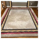 Custom-made carpet with a mostly grey-tan field and a black and braided red middle border; 8 x 12 ft