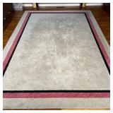 COLORBLOCK AREA RUG | Custom-made carpet with a mostly grey-tan field and a black and braided red mi