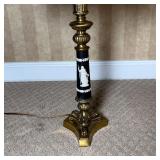 column with white raised laurel leaves and the figure of a woman holding a bird, having two light bu