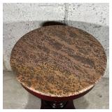 STONE PEDESTAL TABLE | Textured stone top over a turned wood pedestal and four carved feet; dia. 22 