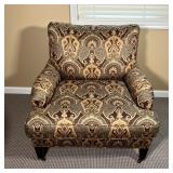 CUSTOM MADE ARM CHAIR | Paisley print armchair with two brass casters on the front legs, custom hand