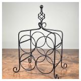 WIRE METAL WINE RACK | Tabletop wine rack, holds 4 bottles, with twisted finial and scroll feet; h. 