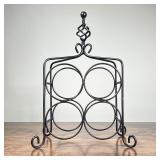 WIRE METAL WINE RACK | Tabletop wine rack, holds 4 bottles, with twisted finial and scroll feet; h. 