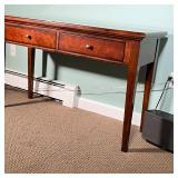 Solid wood with a dark finish, having two frieze drawers over square tapering legs; h. 29-1/2 x 18 x