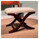 X-FORM BENCH | Small stool having an upholstered seat with circle patterned fabric over a dark wood 