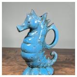 SEAHORSE-FORM BLUE PITCHER | Blue ceramic pitcher with "cracked ice" glaze; h. 13-1/2 in.