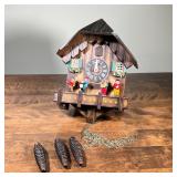 SWISS/GERMAN CUCKOO CLOCK | Round dial with Roman numeral markers, the face marked "Germany", with p