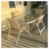 dining set, including a glass top table of oval shape with 4 stacking chairs, in very good and clean