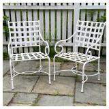 PAIR OUTDOOR ARMCHAIRS | White strap work patio dining chairs with scrolled arms and crossed demilun