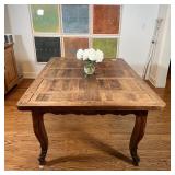 CUSTOM DINING TABLE | Old wood board top resting on a carved apron over cabriole legs, no apparent m