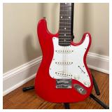 FENDER SQUIER ELECTRIC GUITAR | Red and white guitar on an On-Stage Stand (guitar h. 34-1/2 in.) [mi