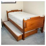 OAK TRUNDLE BED | Twin size oak bed frame of nicely figured wood with pullout trundle, two mattresse