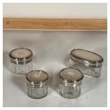 (4pc) SILVER LIDDED JARS | Small glass jars, each with an engine turned sterling silver lid with Eng