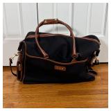 T. ANTHONY DUFFLE BAG | Black canvas with brown leather detailing, monogrammed D.M.B.; approx. 14 x 