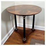 ROUND HALL TABLE | Burlwood veneer top on three ebonized and gilt legs joined at the base; h. 29 x d