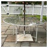 outdoor dining table with a Basta Sole umbrella on a white square stand; table h. 29 x dia. 61 in.