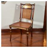 mirrored highlights and painted details, having caned seats and backrests, with gold silk seat cushi