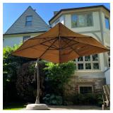 LARGE PATIO UMBRELLA | Brown "Sunbrella" umbrella shade on a hooked stand; approx. h. 120 in.