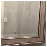 LARGE BEVELED MIRROR | Beveled glass wall mirror in a silvered frame; overall 48 x 28 in.