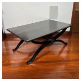 BLACK & GILT COFFEE TABLE | Black lacquered wood coffee table, with a rectangular top on a scrolled 