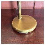 Table lamp with two way switch on a polished brass articulating base with conical shade and diffuser