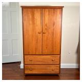 OAK WARDROBE CABINET | Made in USA, two cabinet doors over two drawers; h. 60 x w. 34 x d. 20 in.