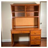 OakDesigns, in two pieces, the top section with a bulletin board backing beneath four shelves; overa