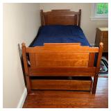 twin bed frame with a pullout trundle for extra sleeping space or storage space, with one twin mattr