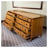 contrasting wood, having two banks of four drawers, each with double pulls and matching escutcheon, 