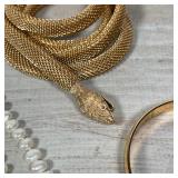 COSTUME JEWELRY | Including a snake-form necklace, a choker, gold-toned bracelets, a lucky four leaf