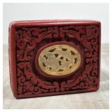 CHINESE CINNABAR BOX | Carved cinnabar with a carved stone plaque, h. 1-3/4 x 3-3/4 x 2-3/4 in.