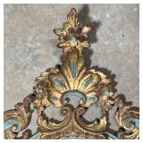  Carved, gilt, and polychrome framed oval wall mirror with Rococo decorations, h. 30 x 18 in.