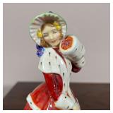 Two figures of women in red gowns, each marked on the bottom, including "Christmas Morn" and "The Er