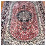 with central medallion on an oval ground within floral patterned borders, appearing in overall very 