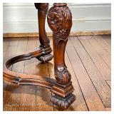 With contemporary patterned velvet upholstery over extensively carved legs joined by an x-stretcher;