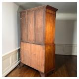 the lower section with four full-width graduated drawers with double brass ring pulls, of two-piece 