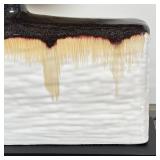 Southwestern style, having a large pottery base with sparkling glazed top and drip accents, on a bla