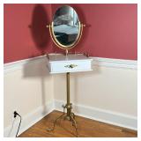 VANITY TABLE | Oval mirror over a 3/4 gallery surface with a single drawer, on a brass tripod base; 