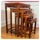 Carved wood nesting side tables with openwork branch borders decorated with carved bird and flowers;