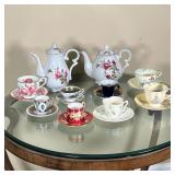 (22pc) TEA CUPS & POTS | A collection of china demitasse cups and saucers, including Belleek, Aynsle